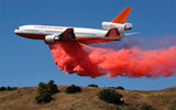 Air tanker dropping fire retardant on fire.
